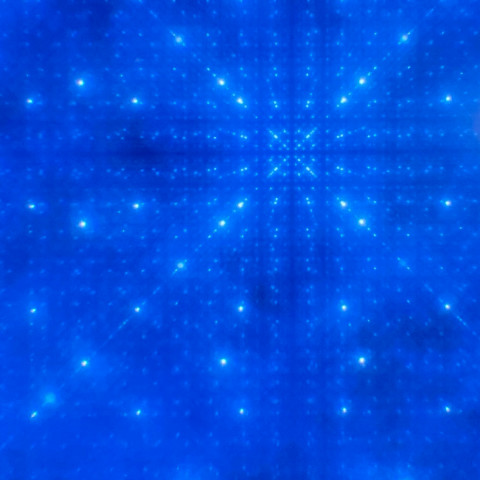 Bright dots arranged symmetrically form straight and intersecting lines against a dark blue background.