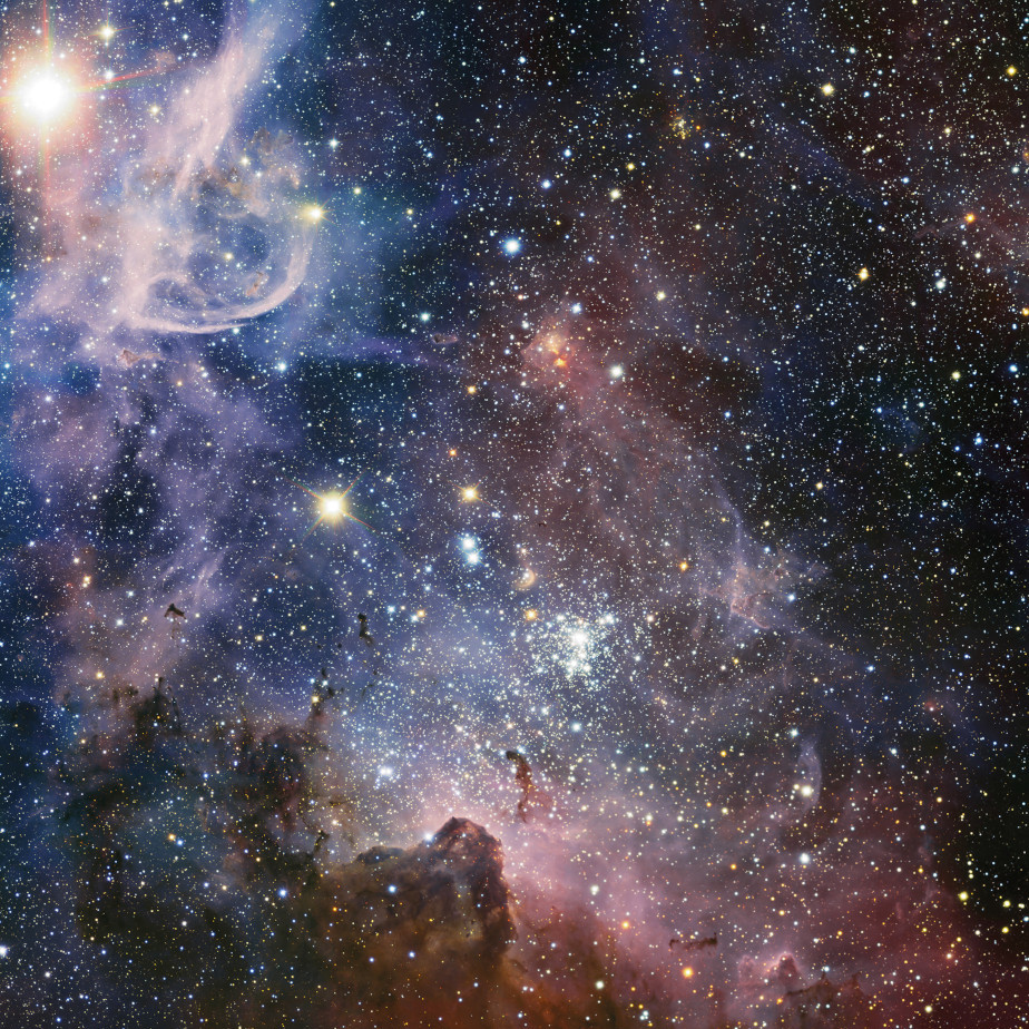 Die farbige Abbildung zeigt bunten Nebel und weiße Sterne im Universum.